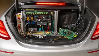 Kofferraum eines silbernen Autos, das mit Hardware zur Ermöglichung des Autonomen Fahrens ausgestattet ist.