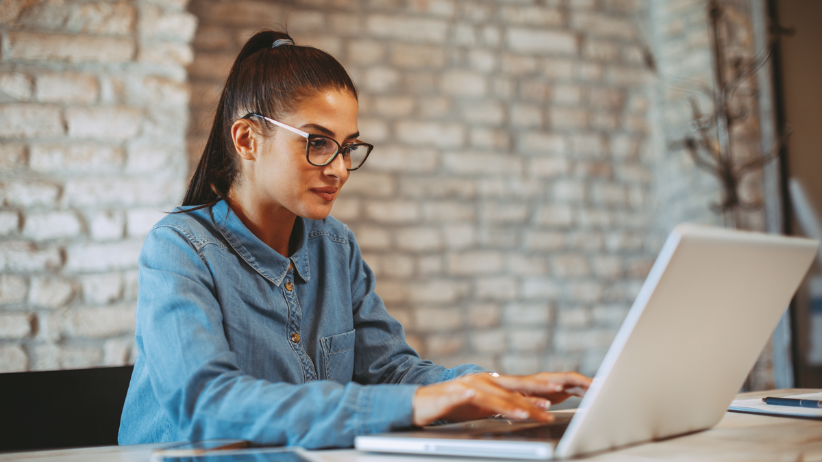 Young woman working on laptop in the office
