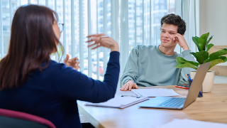 School psychologist, social worker supporting guy student, sitting in office of educational building. Mental health of youth, psychology, psychotherapy, therapy, professional help support