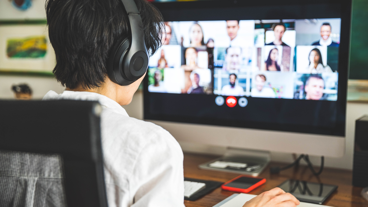 Woman working at home having a video conference with colleagues