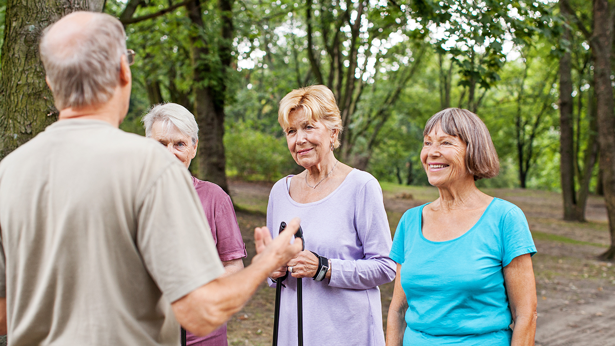 Healthy senior women in the park with fitness instructor