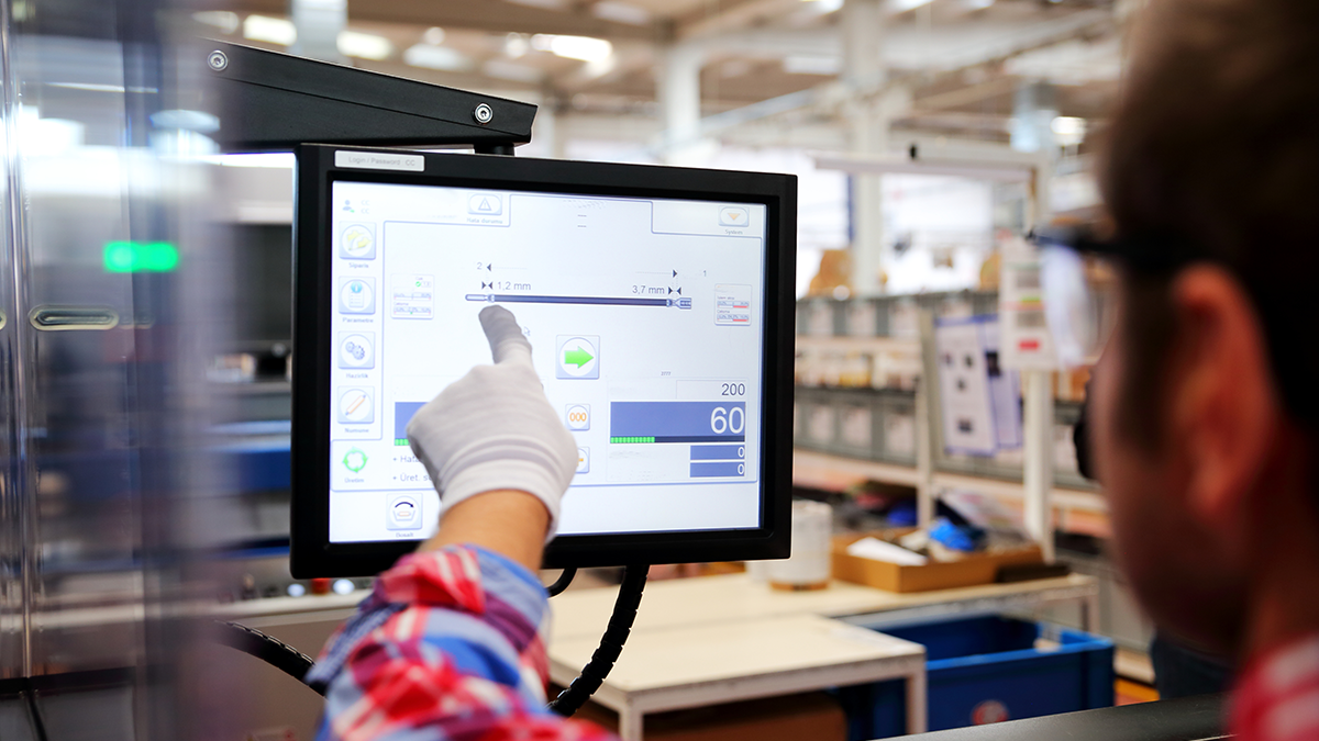 Factory worker uses a monitor 