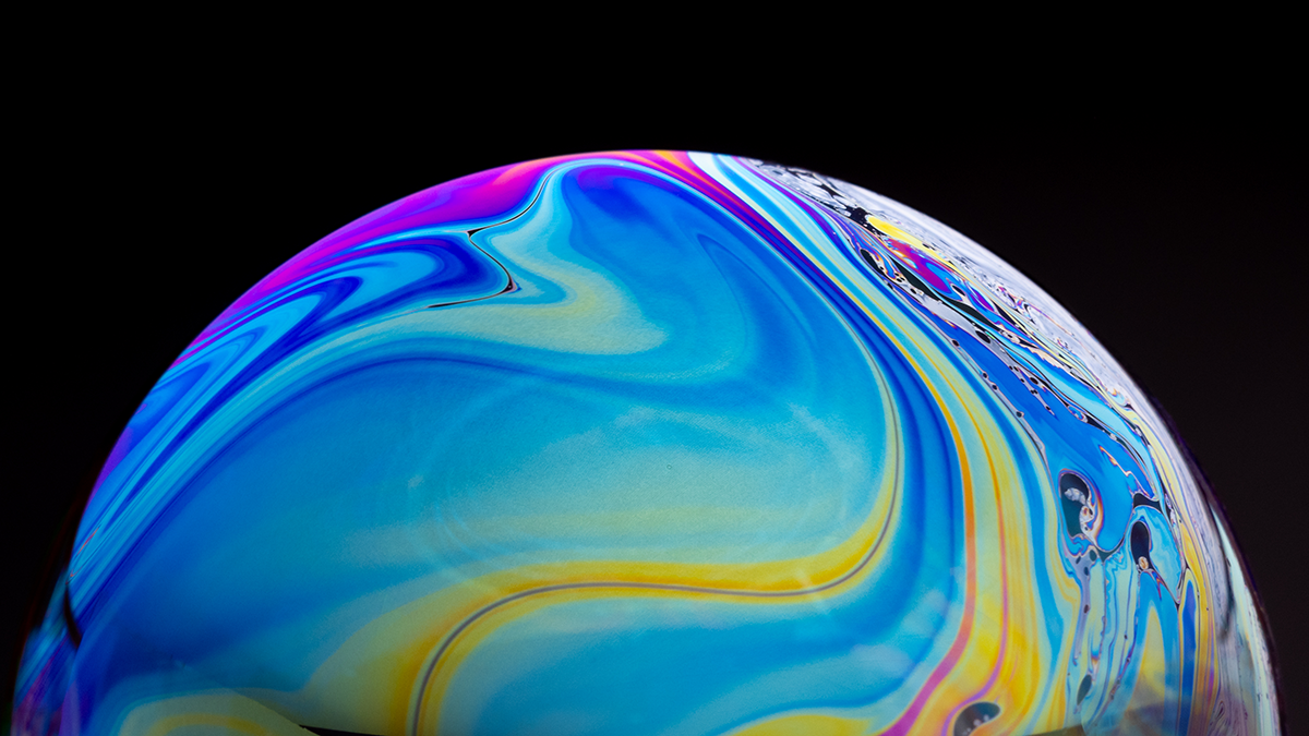 Close up of a colorful soap bubble, looks like a beautiful planet in space.