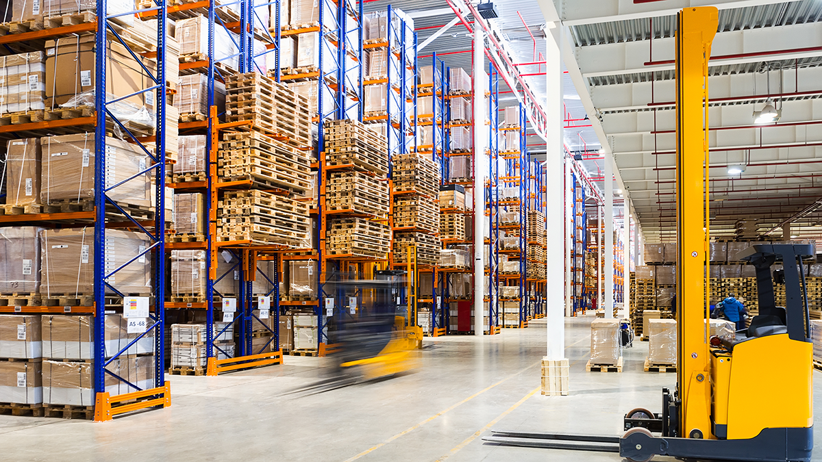 Large modern warehouse with forklifts
