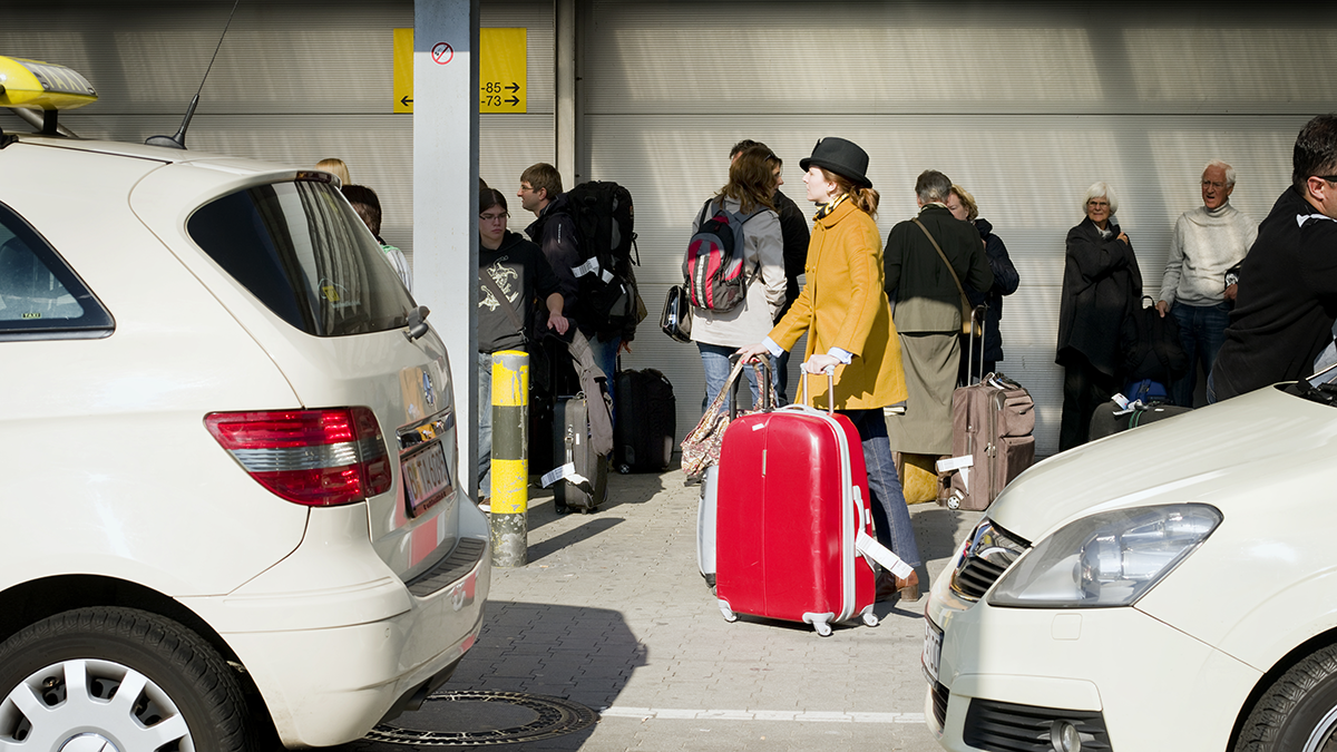 Reisende mit Koffern am ehemahligen Flughafen Berlin Schönefeld (SXF)