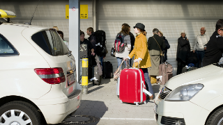 Reisende mit Koffern am ehemahligen Flughafen Berlin Schönefeld (SXF)